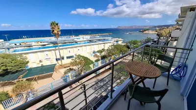 a balcony with a table and a view of the ocean at Sea View Modern 2BR Top Floor on Nea Chora Beach in Chania Town