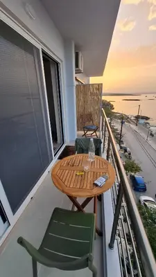 a table and chairs on a balcony with a view of the ocean at Sea View Modern 2BR Top Floor on Nea Chora Beach in Chania Town