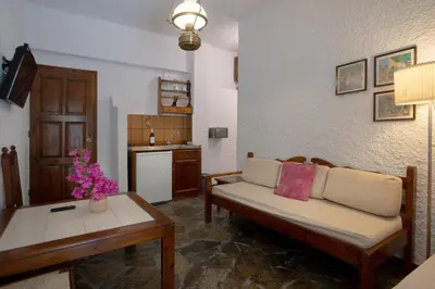 a living room with a couch and a table at Hotel Agapi Apartments in Plataniás