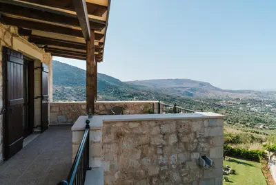 a balcony of a house with mountains in the background at Villa Elia Provarma - Your villa in Chania Town