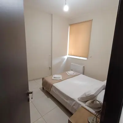 a small bedroom with a bed and a window at Drosoula house in Chania Town