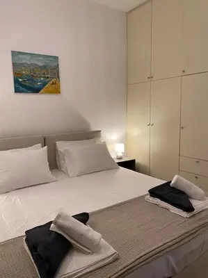 a bedroom with a bed with two towels on it at Be Crete - Zen apartment 2 rooms in Ayiá