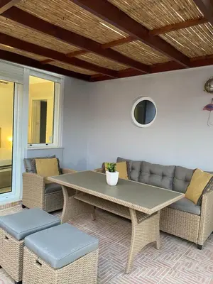 a patio with a table and chairs and a couch at Be Crete - Zen apartment 2 rooms in Ayiá