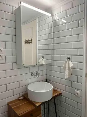 a white bathroom with a sink and a mirror at Perfect home away from home in Palio Gerani