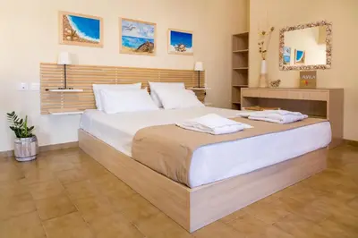 a bedroom with a large bed with two towels on it at Avra Apartments in Kalyves
