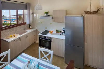 a kitchen with a refrigerator and a sink at Avra Apartments in Kalyves