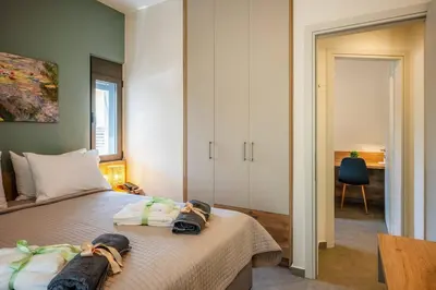 a bedroom with a bed with towels on it at Erato - Newly renovated Home with Parking in Chania Town