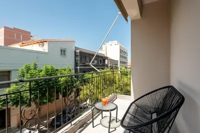 a balcony with a table and chairs on a balcony at Hypnos Luxury Lodgings in Chania Town
