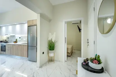a kitchen with white walls and a large mirror at Hypnos Luxury Lodgings in Chania Town