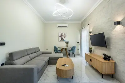 a living room with a couch and a table at Hypnos Luxury Lodgings in Chania Town