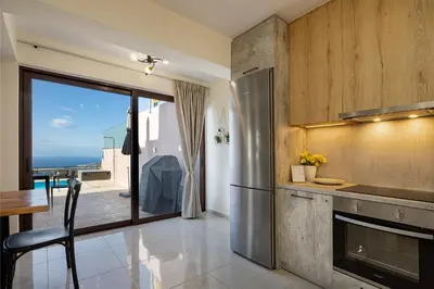 a kitchen with a view of the ocean at Villa Mari mini in Kondópoula