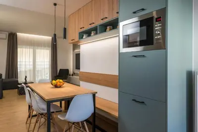 a kitchen with a table and a refrigerator at Be Crete - White Pearl in Chania Town
