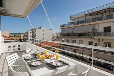 a balcony with a table and chairs on a building at Be Crete - White Pearl in Chania Town