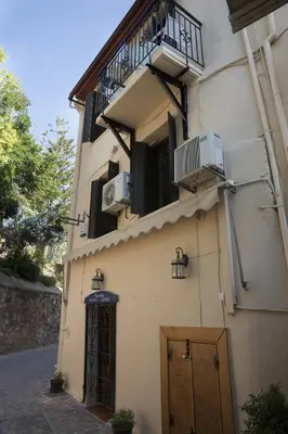 a building with two air conditioners and a balcony at Elia Portou Rooms in Chania Town