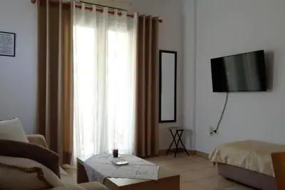 a living room with a couch and a tv and a living room at QUIET NEW Apartment-5' to the beach, 15' to center in Chania Town