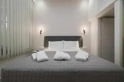 a bedroom with a large bed with two pillows at Peris 4 with Yard steps to Old Town - AC, Wifi in Chania Town