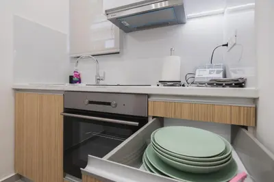 a kitchen with a sink and a pile of plates at Peris 4 with Yard steps to Old Town - AC, Wifi in Chania Town