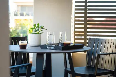 a table with two chairs and a tray of drinks on it at A3stays a cozy vacation retreat in Chania Town