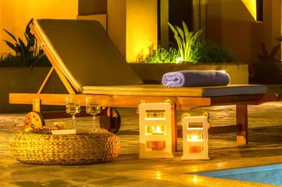 a wooden bench with a table and wine glasses at Cyan Icons Villas Kalyves Chania in Kalyves