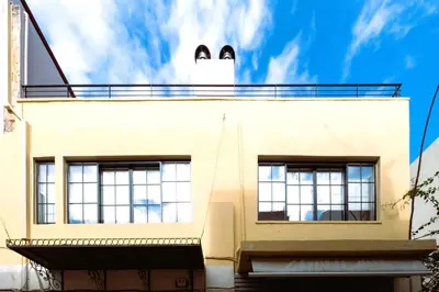 a building with a cat face on the top of it at Citrus Daliani Rooms in Chania Town
