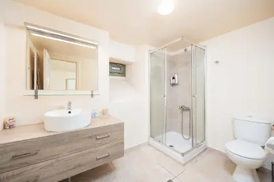 a bathroom with a shower and a sink and a toilet at Villa Nafsika in Vamos