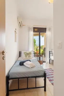 a bedroom with a bed in a room at Almyrida Bay View House III BY APOKORONAS-VILLAS in Almirida