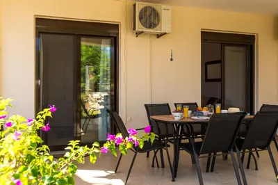 a dining room with a table and chairs at Almyrida Bay View House III BY APOKORONAS-VILLAS in Almirida