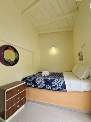 a bedroom with a bed and a dresser in it at Stefanos Garden3 in Arménoi