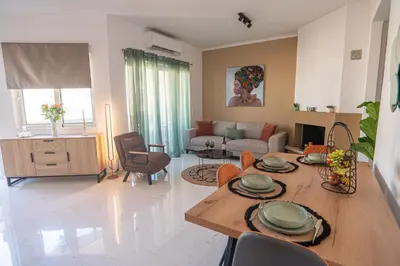 a living room with a table and a couch at CityNest apartment in Chania Town