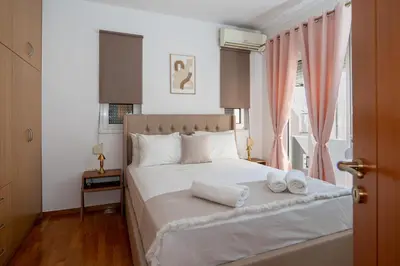a bedroom with a bed with two towels on it at CityNest apartment in Chania Town