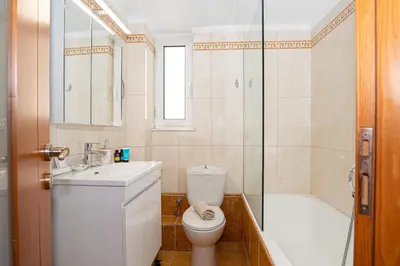 a bathroom with a toilet and a sink and a shower at CityNest apartment in Chania Town