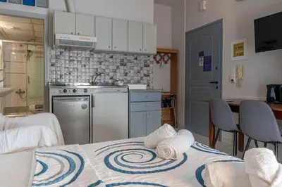 a kitchen with a table with towels on top of it at Alena Apartments in Chania Town
