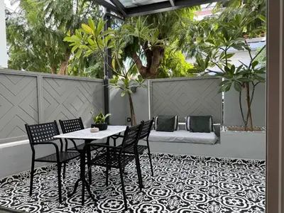 a patio with a table and chairs and a couch at Ethyr Atrium in Chania Town