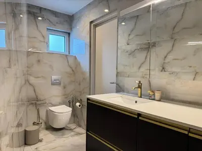 a bathroom with a sink and a toilet at Ethyr Atrium in Chania Town