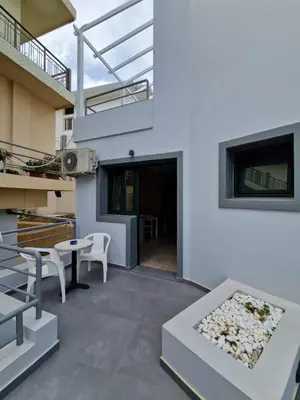 a patio with a table and chairs on a building at Rainbow Hotel Apartments in Chania Town