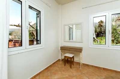 a room with a desk and two windows at Elafonisi - Cretan Serenity - Private Pool in Elafonisi