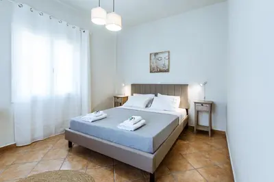 a bedroom with a bed with towels on it at Elafonisi - Cretan Serenity - Private Pool in Elafonisi