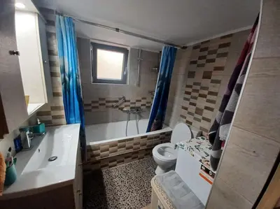 a bathroom with a toilet and a tub and a sink at Kristy's House with garden in Chania Town