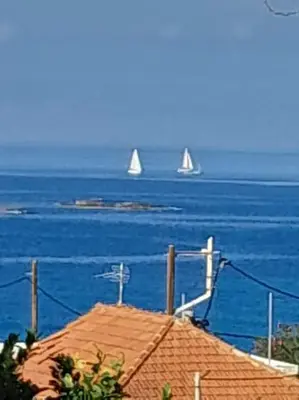 two sail boats in the water with a house at Kristy's House with garden in Chania Town