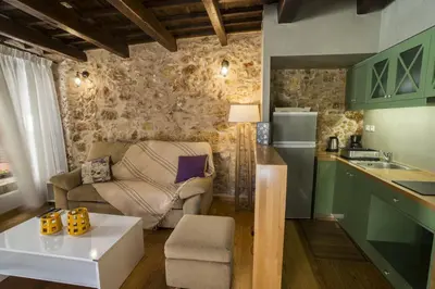 a kitchen and living room with a couch and a table at Eulogia Casa in Chania Town