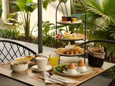 a breakfast table with eggs and bread and drinks at Nearchou Boutique Hotel in Chania Town