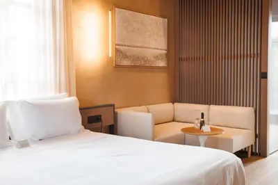 a hotel room with a bed and a couch and a table at Nearchou Boutique Hotel in Chania Town