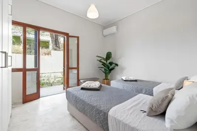 a bedroom with two beds and a sliding glass door at STR Sodi The View in Chania Town