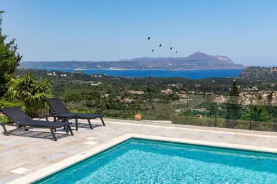 a villa with a swimming pool and a view at Villa Anthos - Superb panoramic sea and hill views with private pool in Gavalochori
