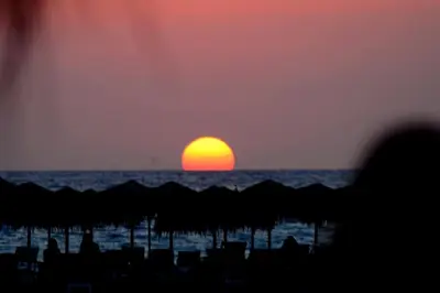 a sunset over the ocean with the sun in the horizon at Seli Chrysi - Apartment near the Sea in Kámbos