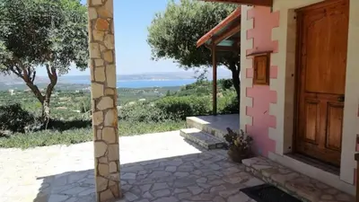 a door to a house with a view of the ocean at Villa Oneiro Tsivaras in Tsivarás