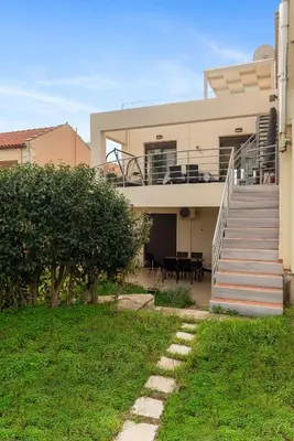 a house with a staircase in front of it at Almyrida Bay View House V BY APOKORONAS-VILLAS in Almirida