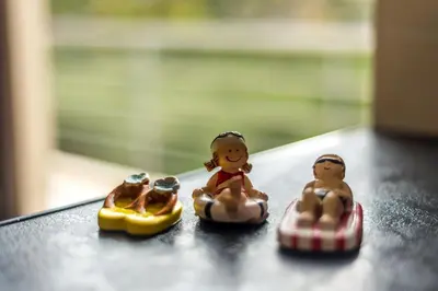 three toy children riding on toy cars on a table at Almyrida Bay View House V BY APOKORONAS-VILLAS in Almirida