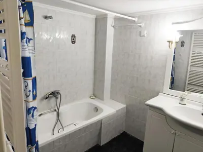 a bathroom with a bath tub and a sink at Coastal Retreat in Nea Chora in Chania Town
