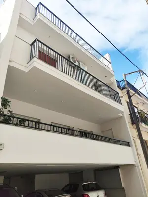 a white building with a balcony at Coastal Retreat in Nea Chora in Chania Town